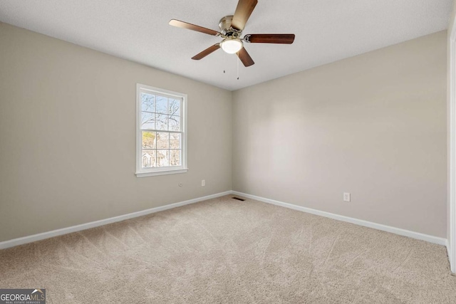 carpeted empty room featuring ceiling fan