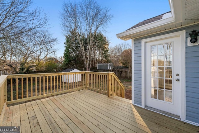 wooden terrace with a storage shed