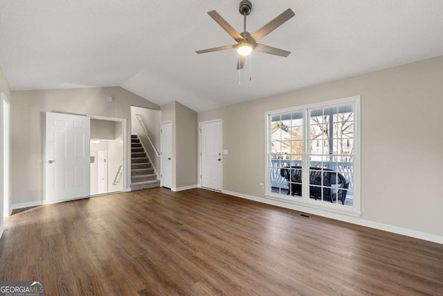 unfurnished living room with lofted ceiling, dark hardwood / wood-style floors, and ceiling fan