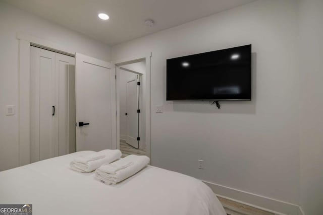 bedroom featuring a closet and light hardwood / wood-style flooring