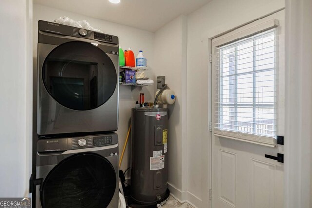 laundry room with stacked washer and dryer and electric water heater