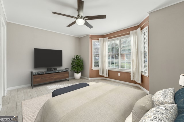 bedroom featuring ornamental molding, ceiling fan, and light wood-type flooring