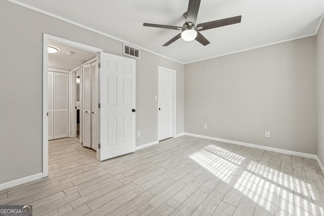 bedroom with ornamental molding, ceiling fan, and light wood-type flooring