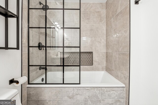 full bathroom with vanity, toilet, and tiled shower / bath combo