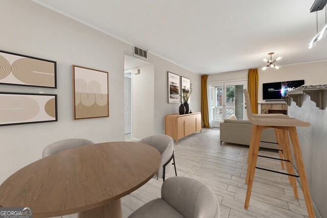 dining area with a chandelier and light hardwood / wood-style floors