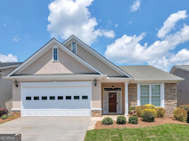 view of front facade featuring an attached garage, stone siding, concrete driveway, and stucco siding