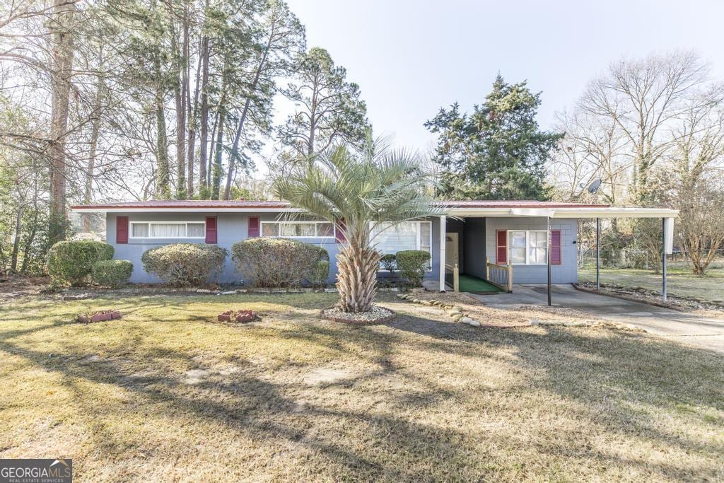 ranch-style house with a carport and a front yard