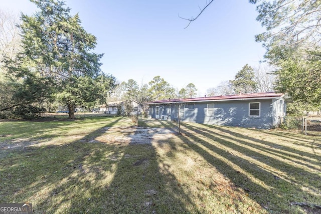 back of house with a lawn