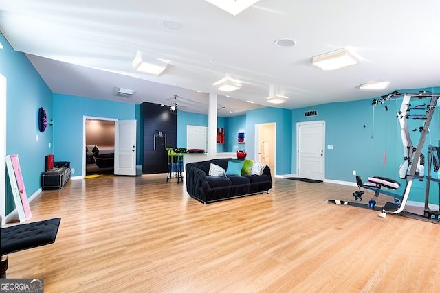 workout area with light hardwood / wood-style floors