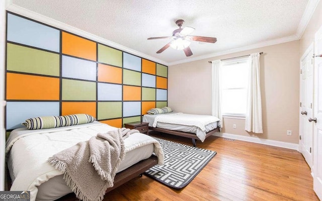 bedroom featuring crown molding, a textured ceiling, and light hardwood / wood-style floors