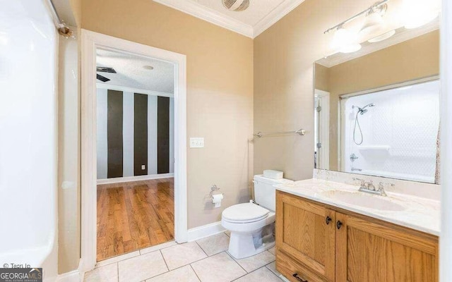 bathroom featuring vanity, ornamental molding, a shower, tile patterned floors, and toilet