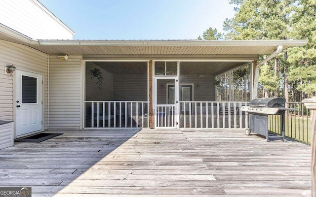 wooden deck with a grill