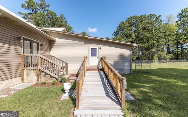 view of exterior entry with a yard