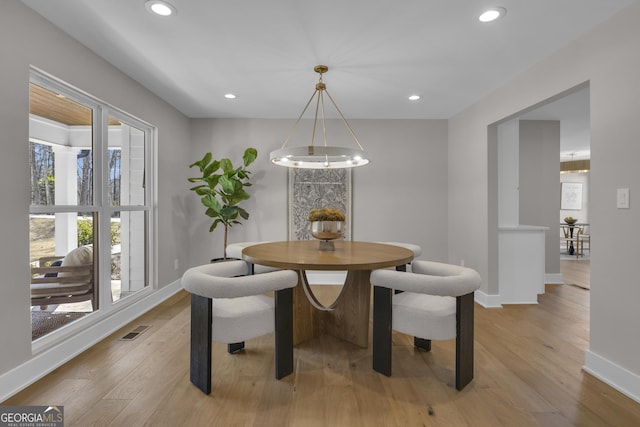 dining space with light hardwood / wood-style floors
