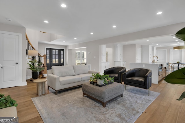 living room featuring sink and light wood-type flooring