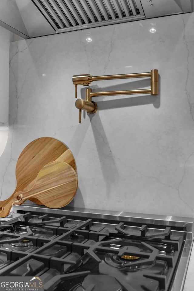 interior details featuring stone counters and stainless steel gas stove
