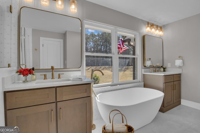 bathroom featuring a tub to relax in, vanity, and a wealth of natural light