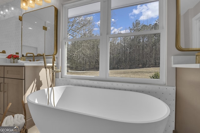bathroom featuring vanity and a tub