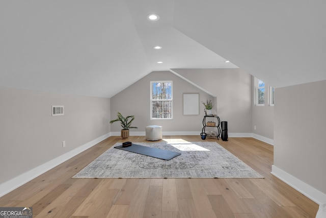 interior space with lofted ceiling and light hardwood / wood-style floors