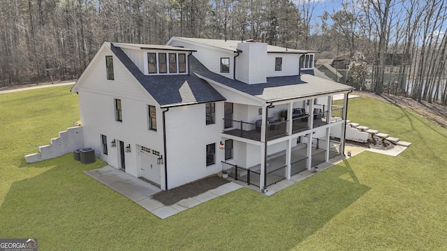 back of house with central AC unit, a lawn, and a balcony