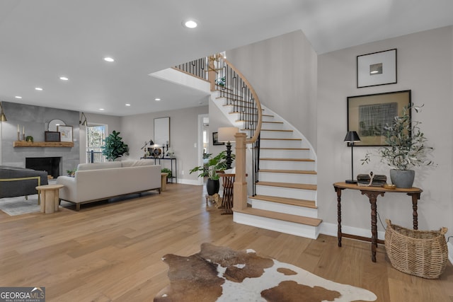 entrance foyer featuring a fireplace and light hardwood / wood-style flooring