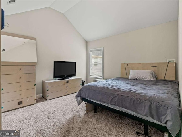 carpeted bedroom featuring lofted ceiling