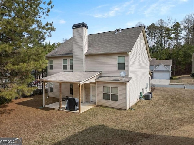 rear view of property with central AC, a garage, a patio, and a lawn