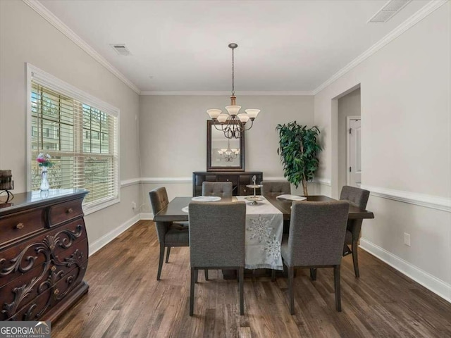 dining area featuring crown molding, dark hardwood / wood-style floors, and a notable chandelier