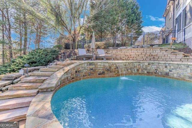 view of swimming pool featuring pool water feature