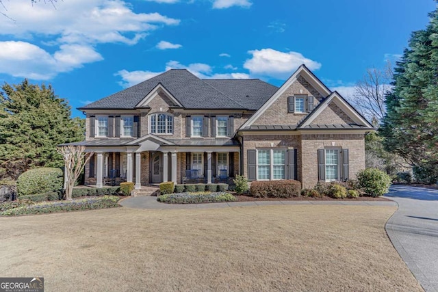 view of front of home featuring a porch and a front lawn