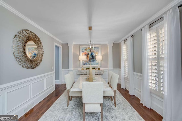 dining room with dark wood-type flooring and ornamental molding