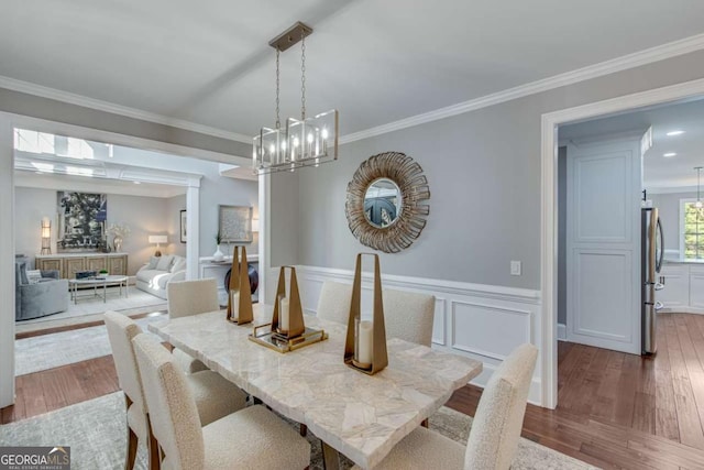 dining room with crown molding and wood-type flooring