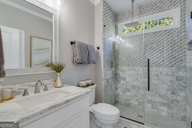 bathroom featuring vanity, a tile shower, crown molding, and toilet