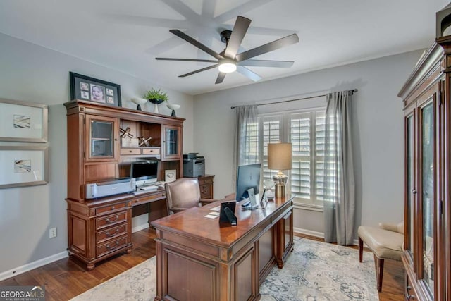 home office featuring dark hardwood / wood-style flooring and ceiling fan