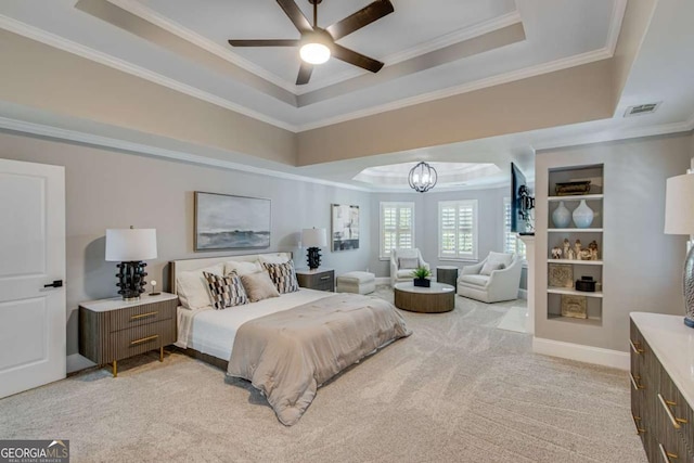 bedroom with ornamental molding, light colored carpet, a chandelier, and a tray ceiling