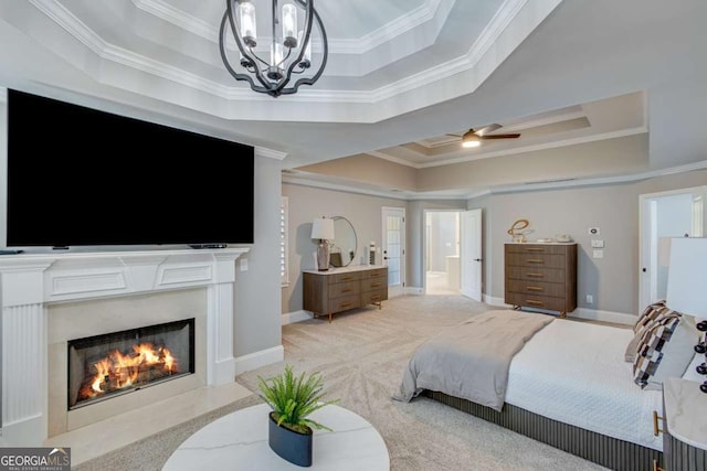 bedroom featuring ornamental molding, light carpet, a notable chandelier, and a tray ceiling