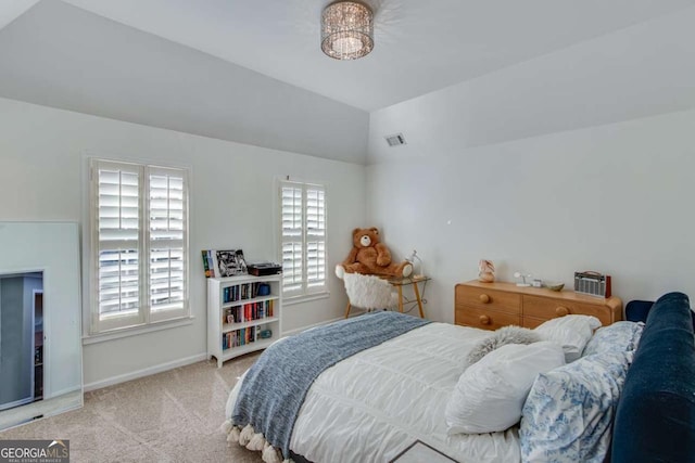 bedroom featuring vaulted ceiling and light carpet