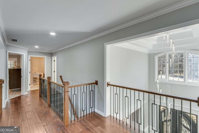 hall featuring hardwood / wood-style flooring and ornamental molding