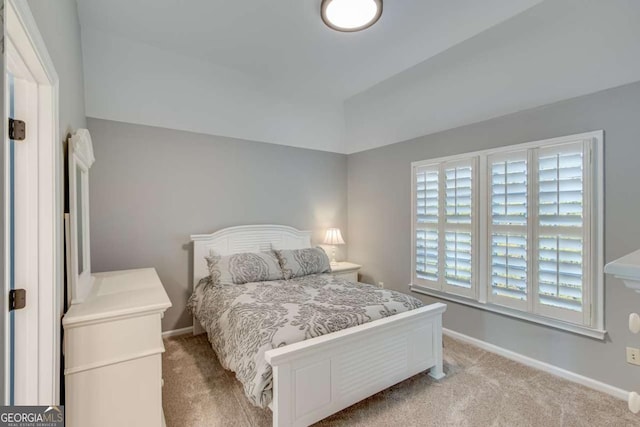 carpeted bedroom with vaulted ceiling