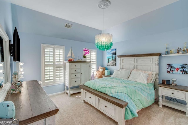 carpeted bedroom featuring vaulted ceiling and a chandelier