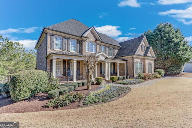 view of front of house with a porch and a front yard