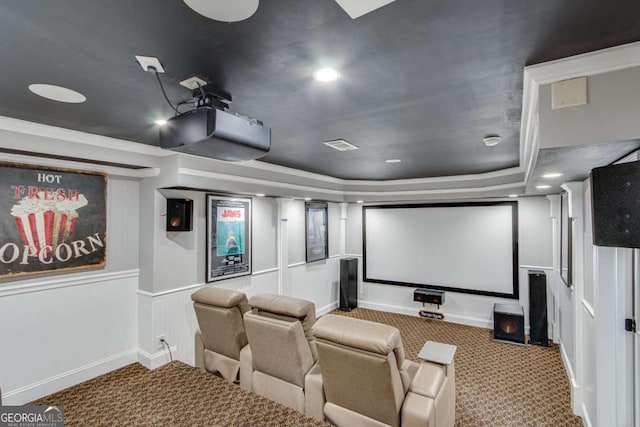 home theater with a tray ceiling and carpet flooring