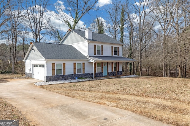 view of front of property featuring covered porch, a front yard, and a garage