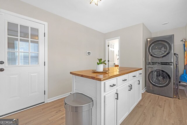 kitchen with decorative light fixtures, appliances with stainless steel finishes, white cabinets, light hardwood / wood-style floors, and backsplash