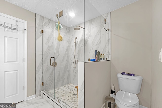 bathroom featuring a textured ceiling, toilet, and walk in shower