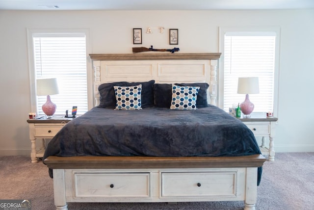 carpeted bedroom featuring multiple windows