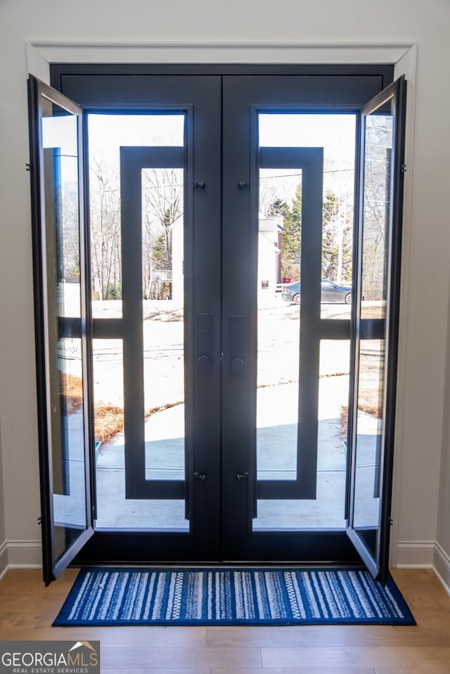 entryway featuring hardwood / wood-style floors and french doors