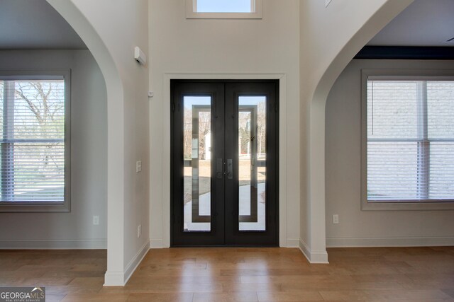 living area featuring light wood-type flooring and beam ceiling