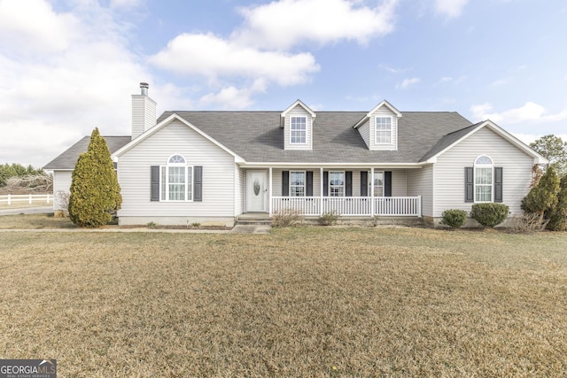 cape cod-style house with a front yard and covered porch