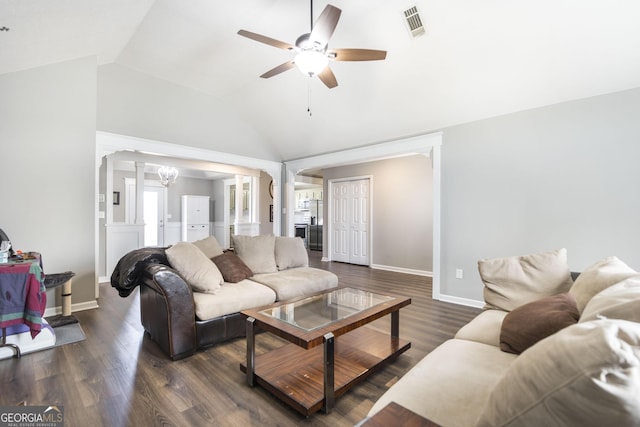 living room featuring lofted ceiling, ceiling fan with notable chandelier, and dark hardwood / wood-style flooring